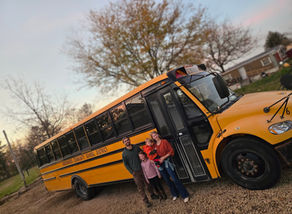 the author and her family, standing in front of their new school bus