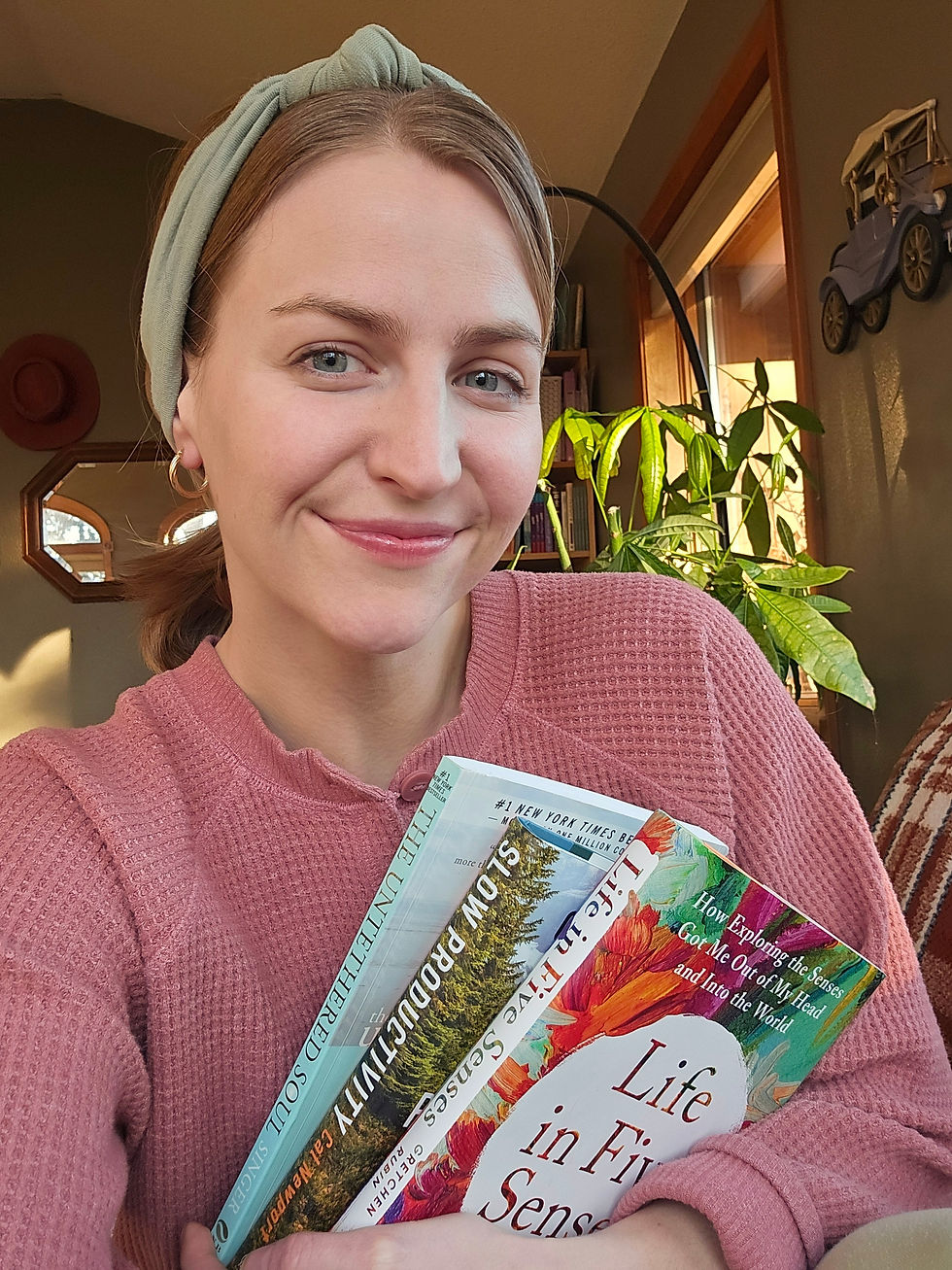 author smiling after surgery, holding three books under her arm