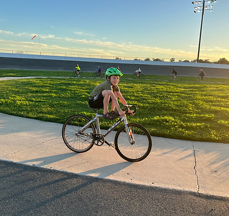 A child riding in the warmup circle at the San Diego Velodrome.