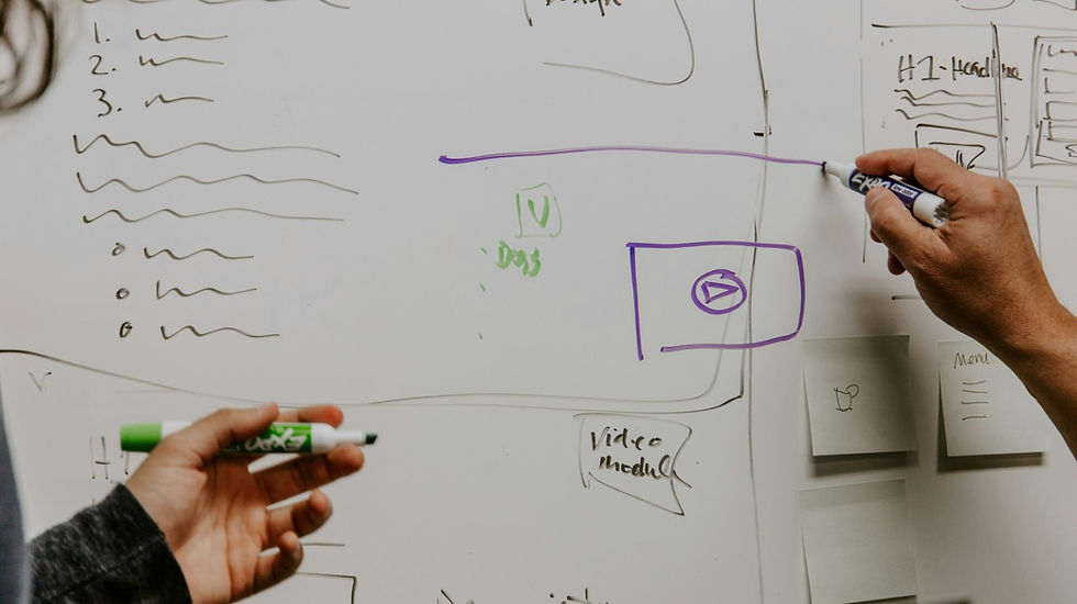 Hands sketching a structured framework on a whiteboard, mapping steps and decision points. illustrating a methodical approach to choosing legal AI with confidence using the FIDAM framework.