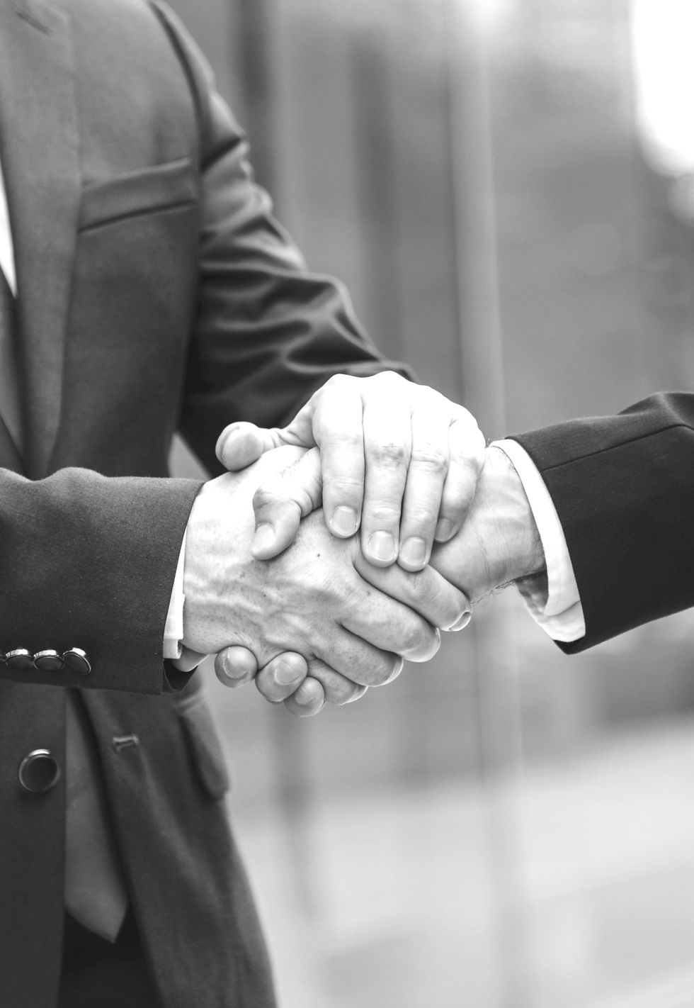black and white photo of people shaking hands