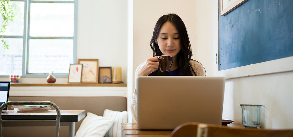 Woman working from her laptop drinking a coffee