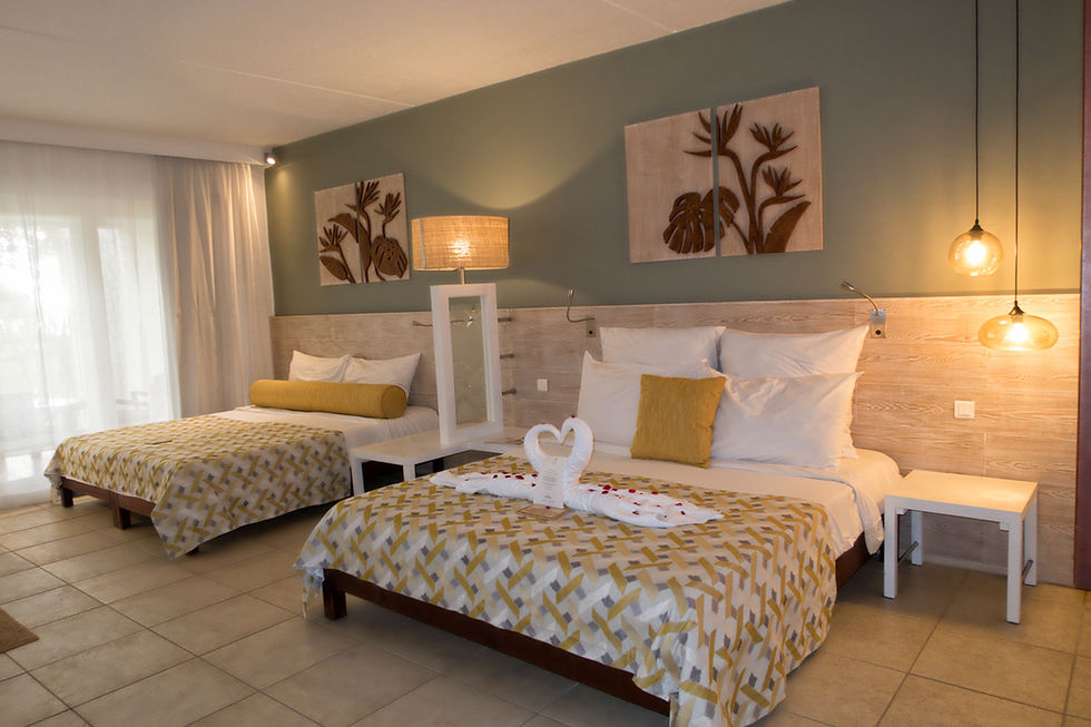 Deluxe group floor room with two king size beds, yellow decor and towels shaped like swans