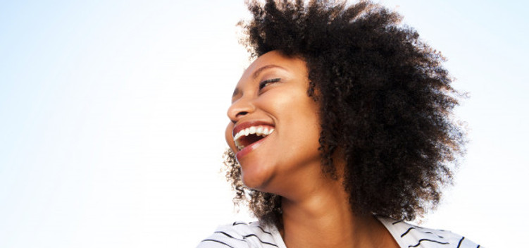 mulher-negra-nova-alegre-que-ri-ao-ar-livre-de-encontro-ao-ceu-brilhante_33839-11588.jpg