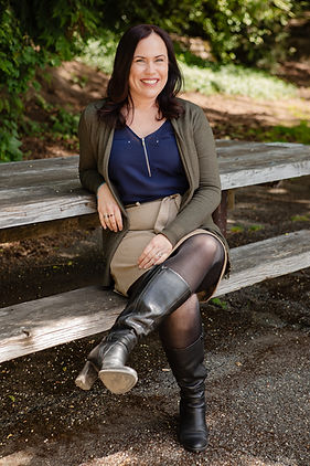Warm, approachable therapist smiling gently, conveying compassion and confidence—specializing in trauma therapy for individuals feeling stuck or seeking deeper healing.