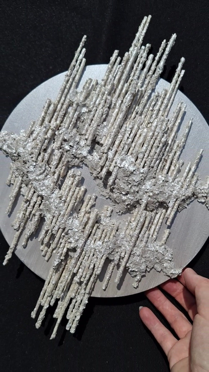 Shiny silver wall-mounted sculpture video