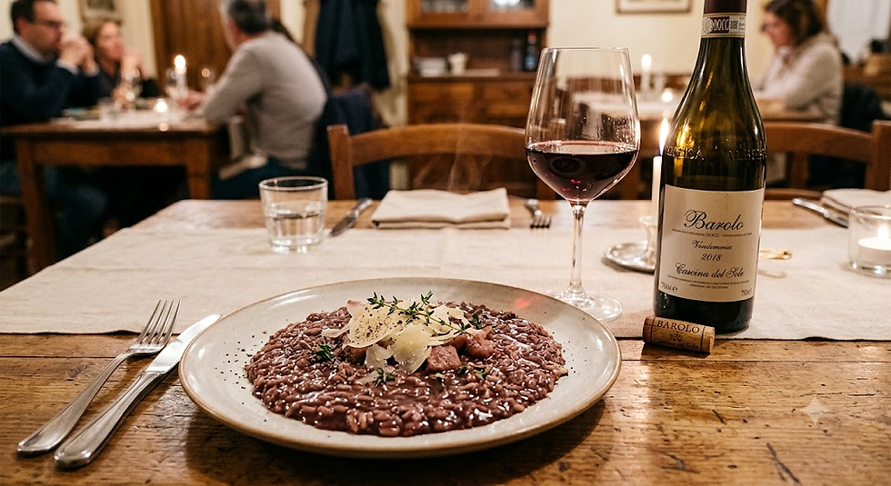 Risotto plate with wine glass and Barolo bottle on a rustic table in a cozy restaurant, diners blurred in back.