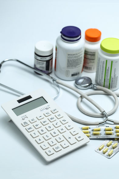 calculator-stethoscope-medicine-bottles-white-background.jpg