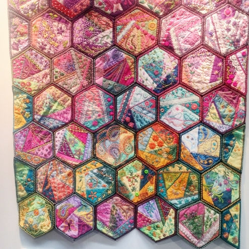 Embroidered hexagons fibre art in a crazy quilt style