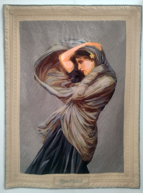 A pictorial art quilt of A Woman holdig her shawl surrounded by wind