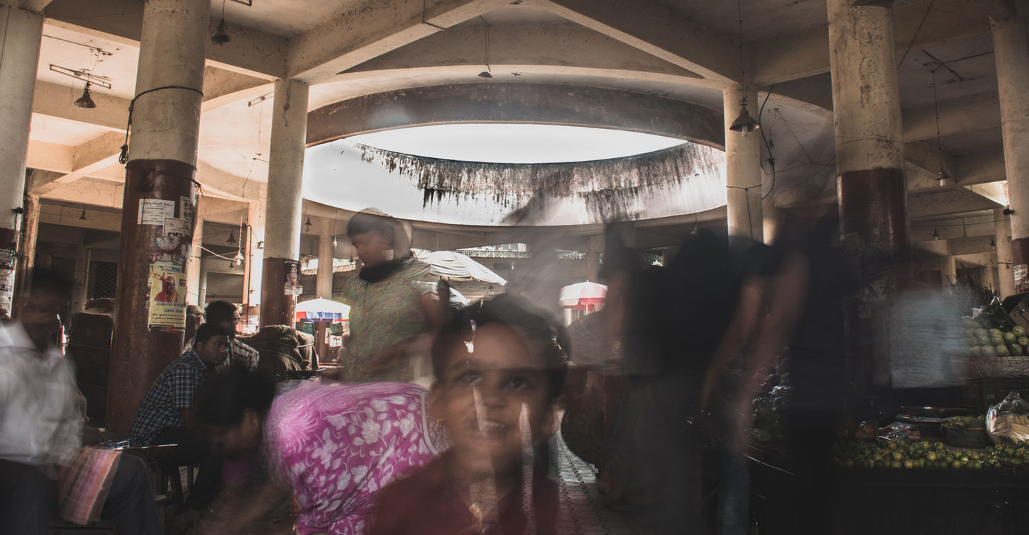Blurred kid amidst a chaotic marketplace in Pune, India. Travel India, incredible India