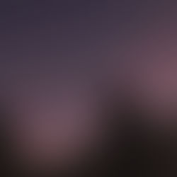 Female somatic therapist looking up to sunset sky and moon