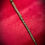 Thumbnail: Ornate wand with green tip, brass rings, The Brass Arcanum Wand on red velvet background.