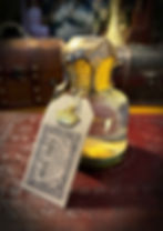 Ornate glass potion bottle with "MIDAS TOUCH" label, golden liquid.