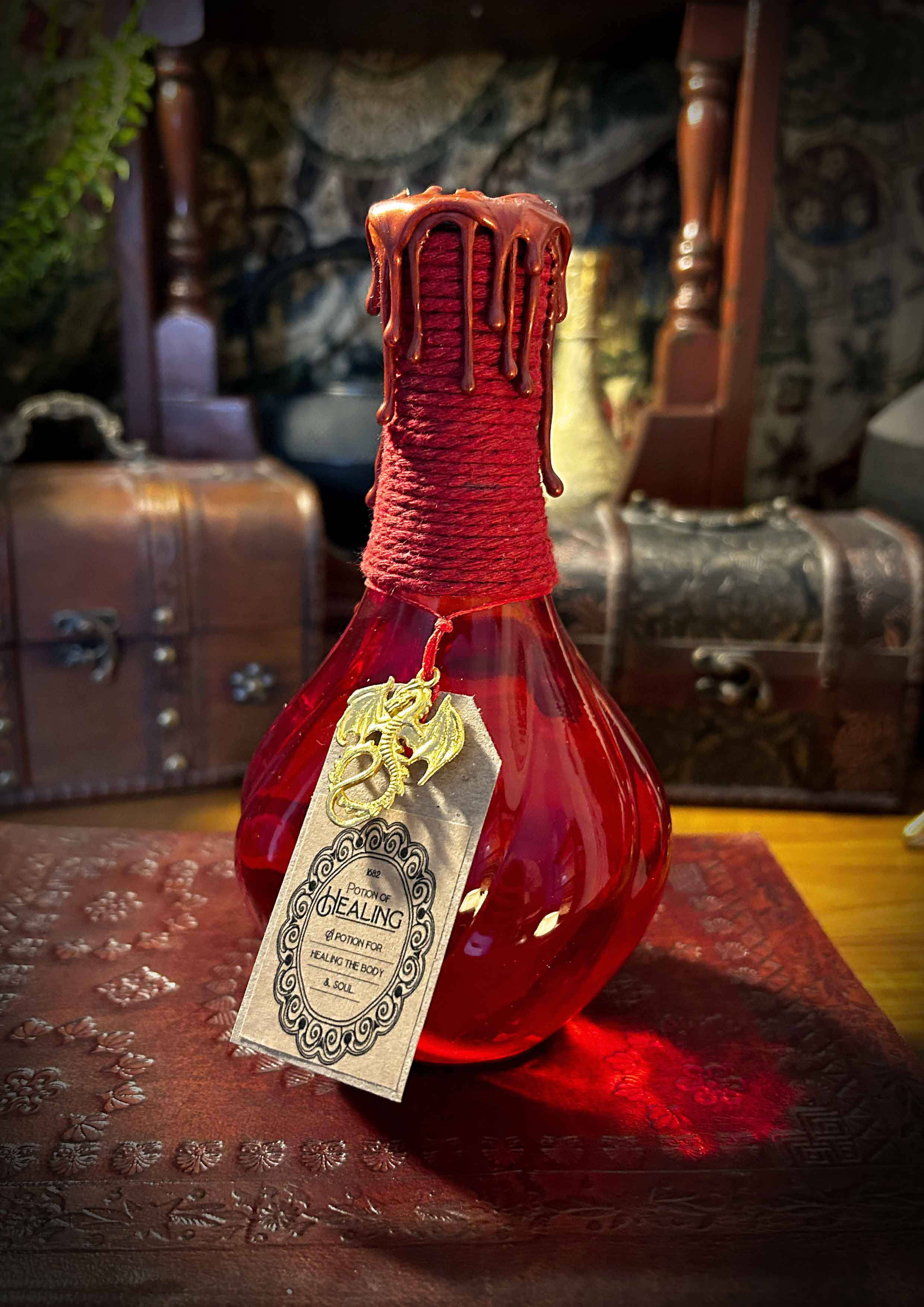 Red potion bottle with ornate "Love Potion" tag and wax seal.