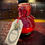 Thumbnail: Small red elixir bottle, ELIXIR OF HEALING BY THE BRASS ARCANUM tag.