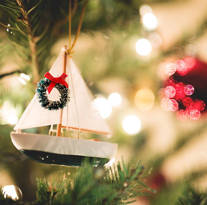 Isolated Sailboat Christmas Tree Ornament with a blurry background.jpg
