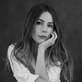 Camila Sodi Woman in black and white, resting chin on hand