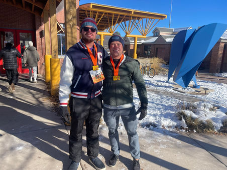 Two men wearing medals stand in snow