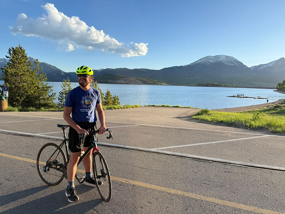 Man with bike by mountain lake