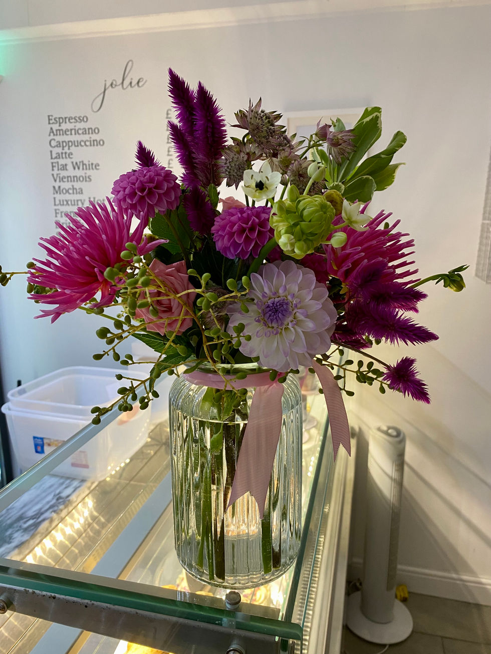 a glass vase filled with pink and purple flowers