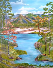 Landscape featuring mountain ranges, river, trees and other vegetation.
