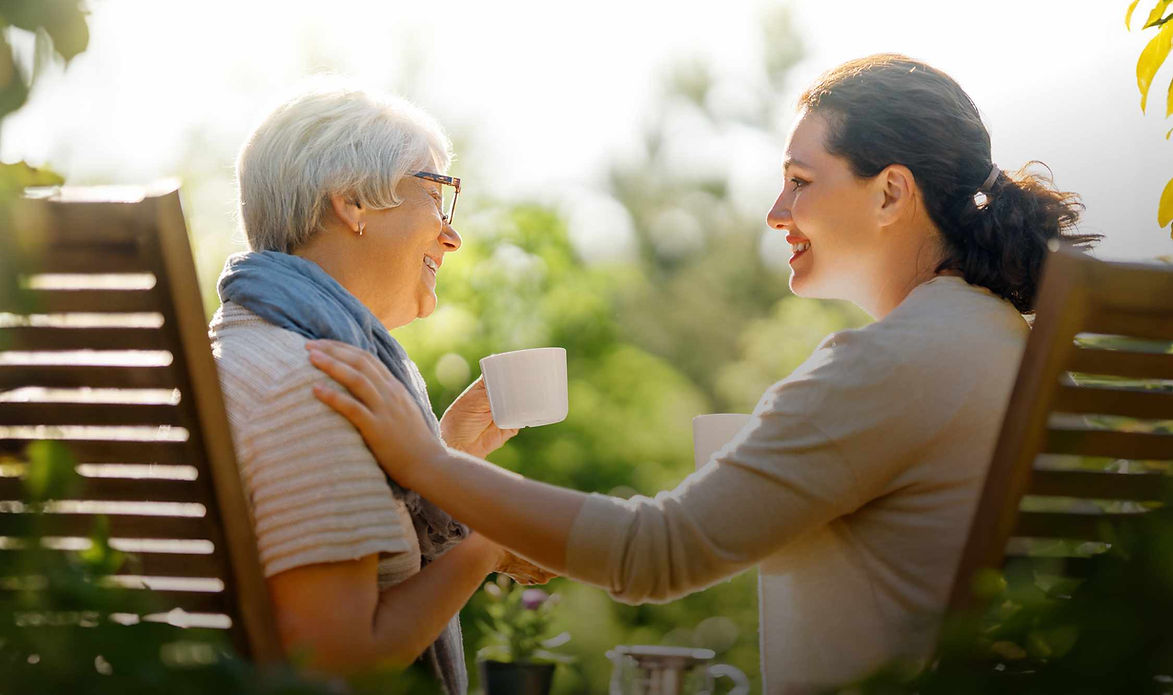Two women in the garden drinking tea