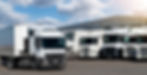 Semi trucks are parked in a row.jpg