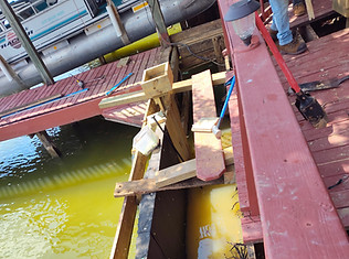 Waterfront bulkhead repair in Texas with visible construction tools and dock-access boat, by Decks on The Water.