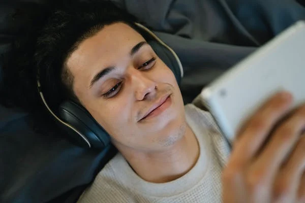 A man on a flight watching a movie on a device