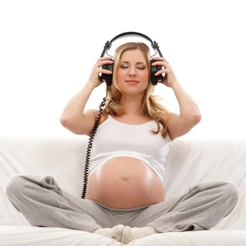 Pregnant woman listening to a Hypnobirthing recording