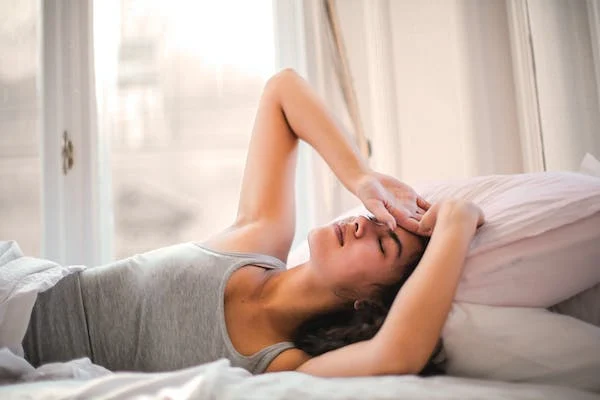 A woman lying on a bed unable to sleep