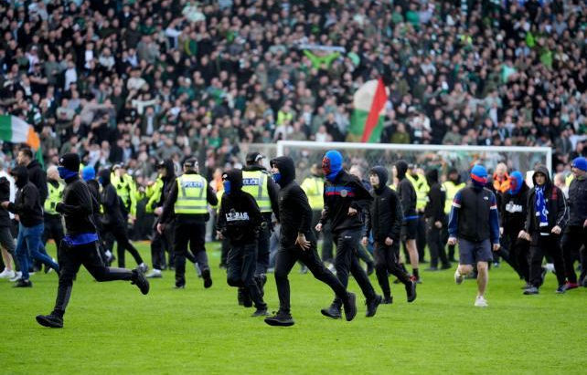 Fans on the pitch at Ibrox.
