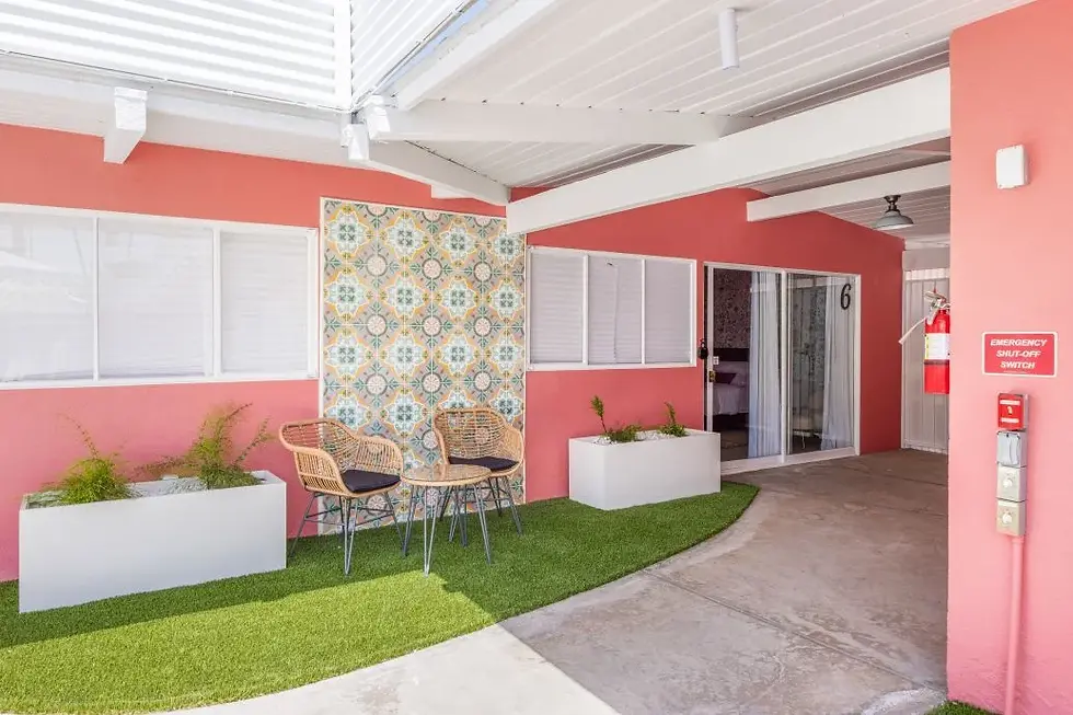 Modern patio at The Muse Hotel Palm Springs with coral walls and rattan chairs, instagram-worthy desert destination