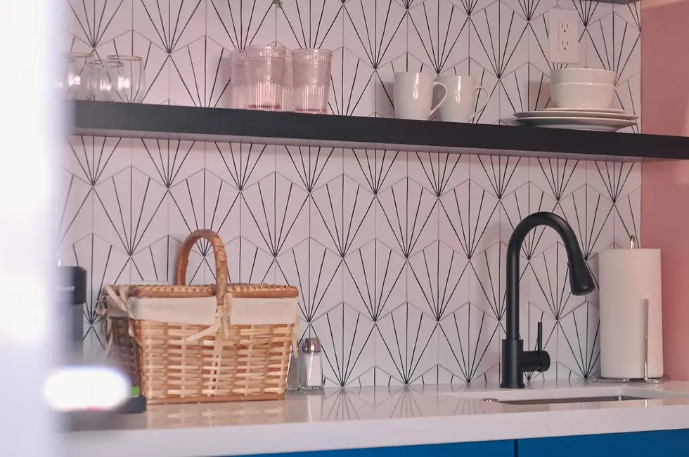 Art deco geometric wallpaper and modern matte black fixtures in Palm Springs mid-century modern bathroom design