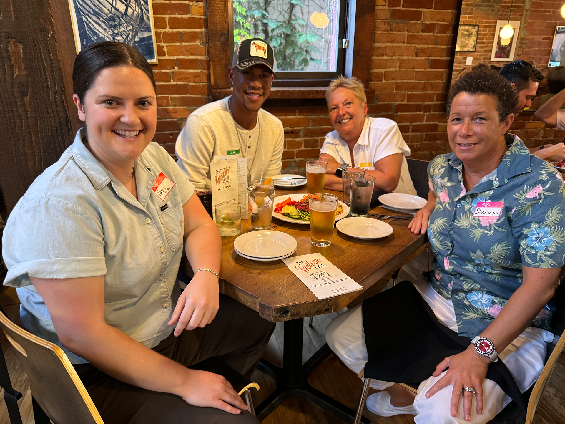 four people sitting down to dinner 