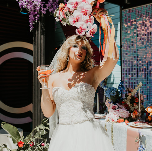 Bride holding flowers to block the sun 