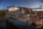 Rock Island Bridge: People dine on a modernized bridge structure over water at sunset. Warm lights illuminate the scene. Multistudio logo visible.