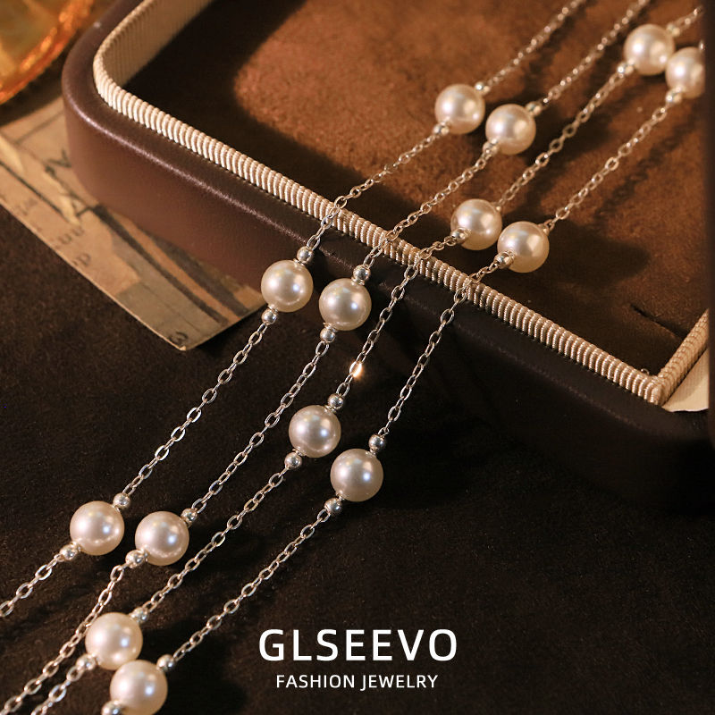 pearl and silver necklace on tray