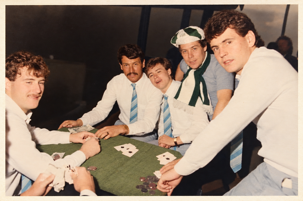 Dad in a green hat playing cards on the way to Wembley