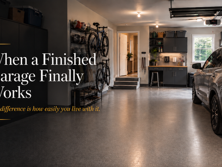 A modern finished garage with a coated floor, organized storage, clear parking space, and an intentional layout supporting everyday household life.