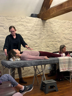 Emma Dando doing an energy therapy demonstration to wellbeing retreat attendees