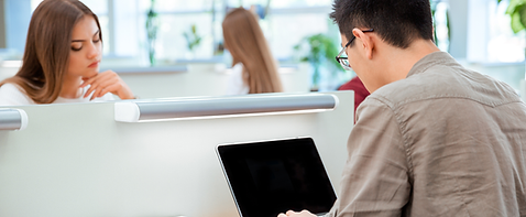 Man on laptop inlibrary.png