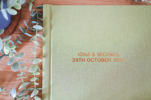 Wedding album cover embossed with a couple's names and wedding date in gold