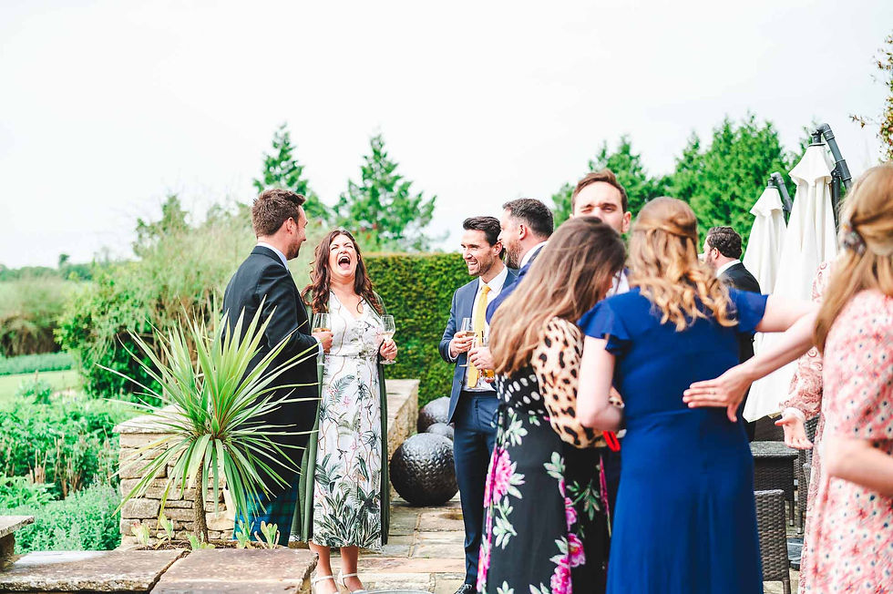 Guests laughing on Cotswold hotel terrace