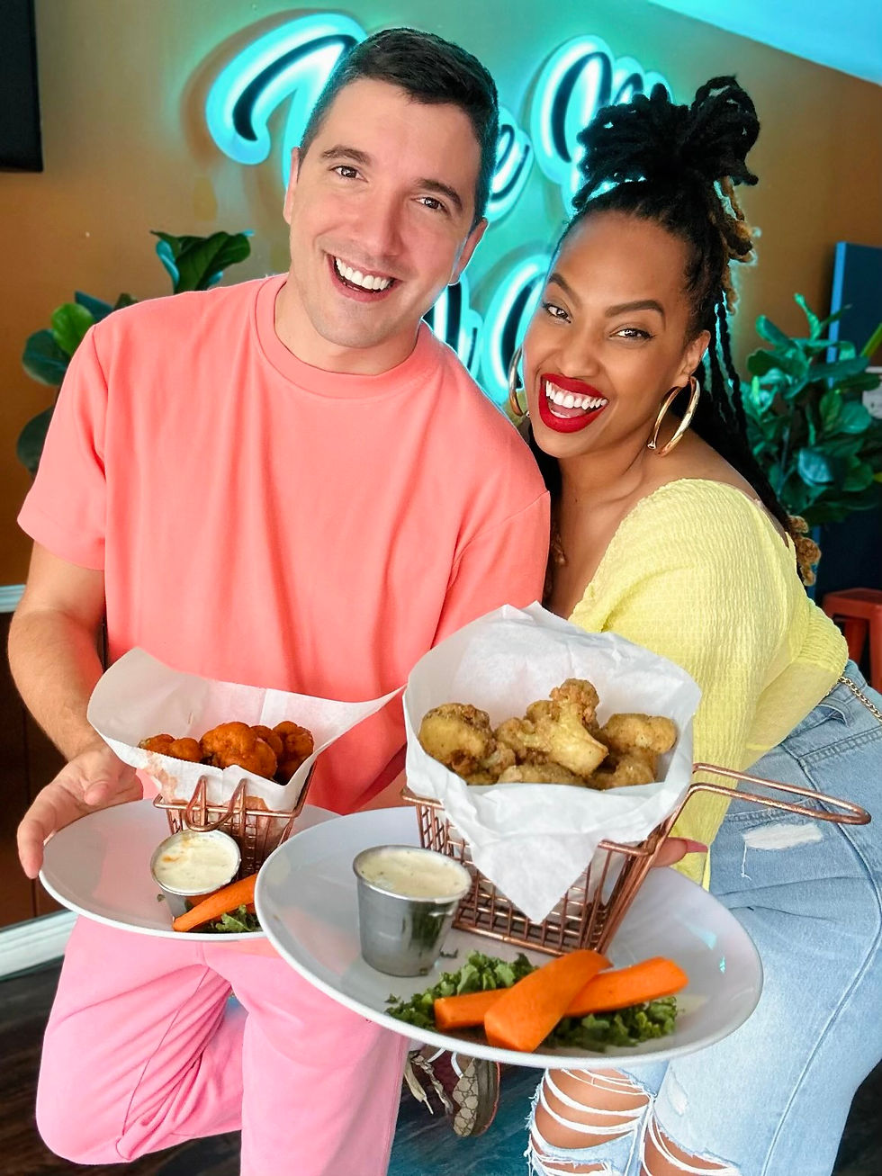 nemanja golubovic and tamika price plant-based tamika holding caulflower wrings at kale my name