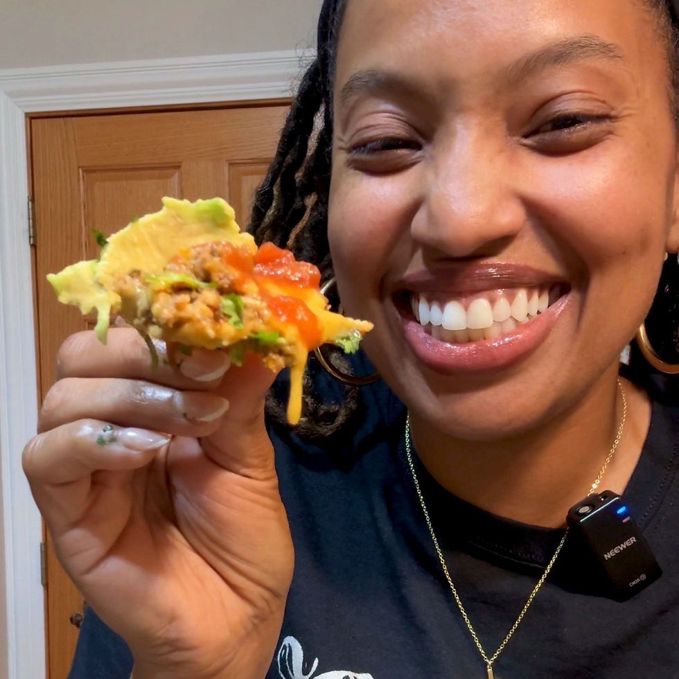 woman holding dripping cheesy nachos smiling