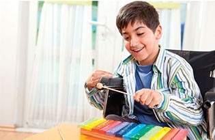 Boy playing zylophone, individual therapy
