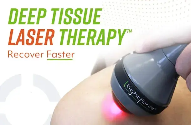 Close-up view of laser therapy device targeting a patient’s shoulder