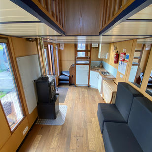 Downstairs area with sofa beds, log burner and fully equipped kitchen. Tinwood 3 Warwickshire glamping with hot tub.